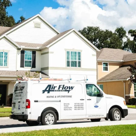 Air Flow Designs Heating & Air Conditioning van parked on the street of a residential neighborhood