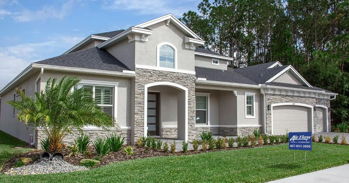 a large, beautiful home with and Air Flow Designs foot sign in the front yard