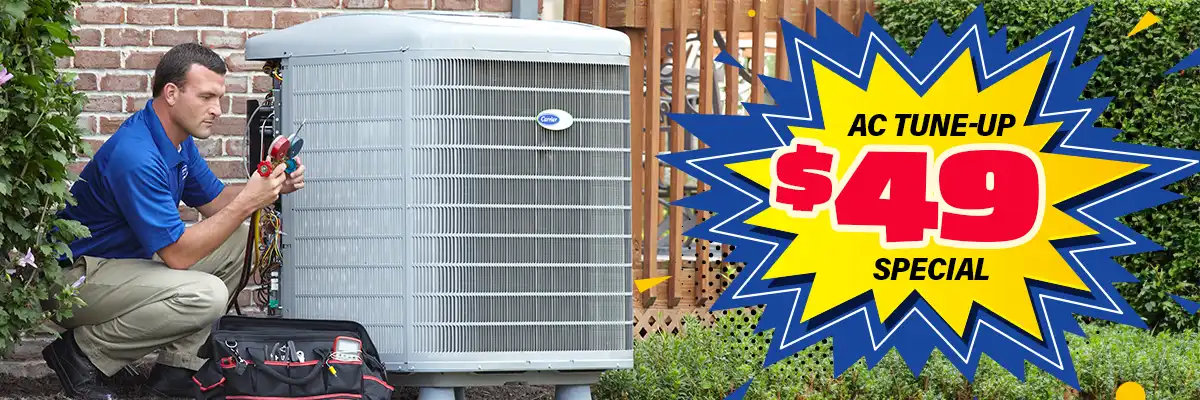 Tech working on an AC with text that reads AC Tune-up Special $49