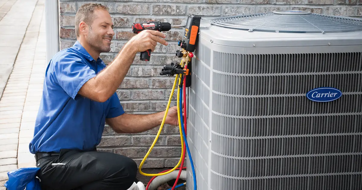 HVAC tech working on an outdoor AC unit