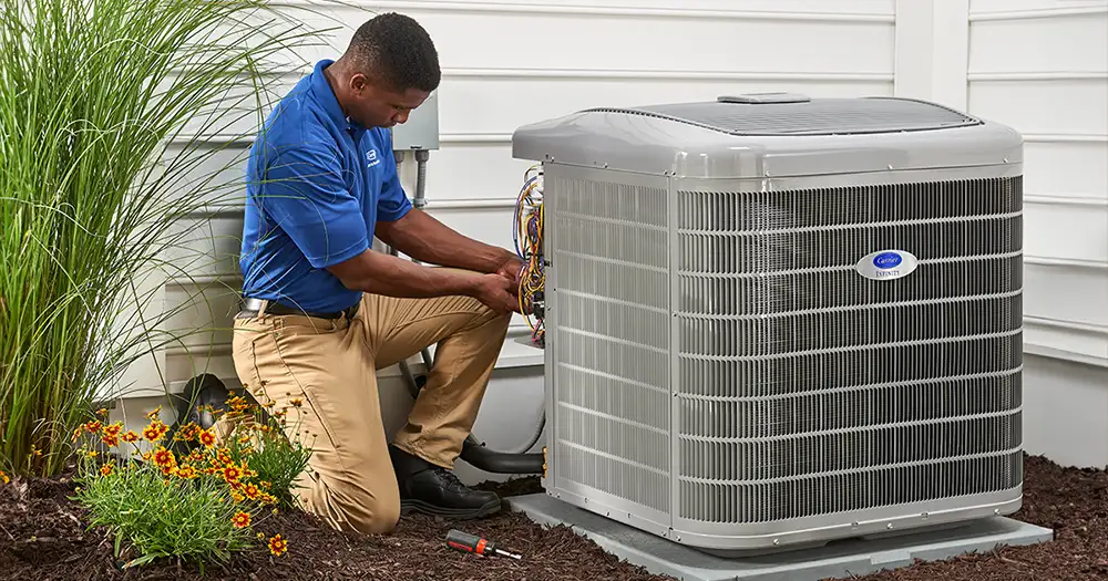 technician installing a carrier air conditioner