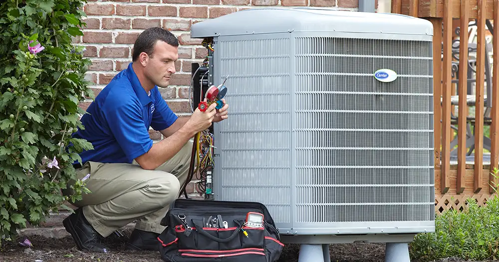HVAC tech working on an outdoor AC unit