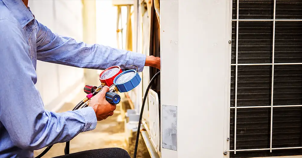 technician working on an AC unit