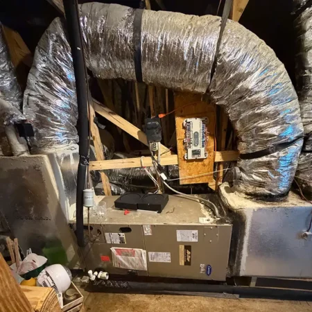 Old air handler in Jacksonville, Florida home attic. Caption reads "BEFORE."
