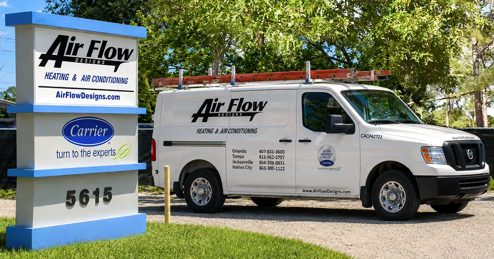 Air Flow Designs van parked beside the monument sign for Air Flow Designs' Jacksonville location.