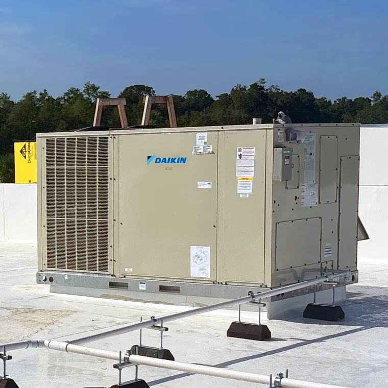 Large Daikin commercial rooftop HVAC unit installed on a white flat roof.