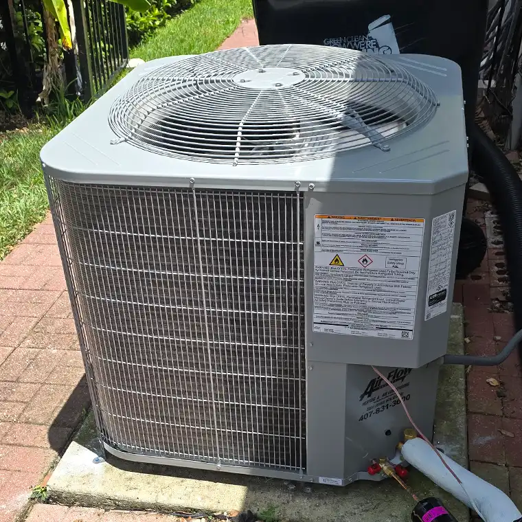 Outdoor AC condenser installed beside a home in Orlando.
