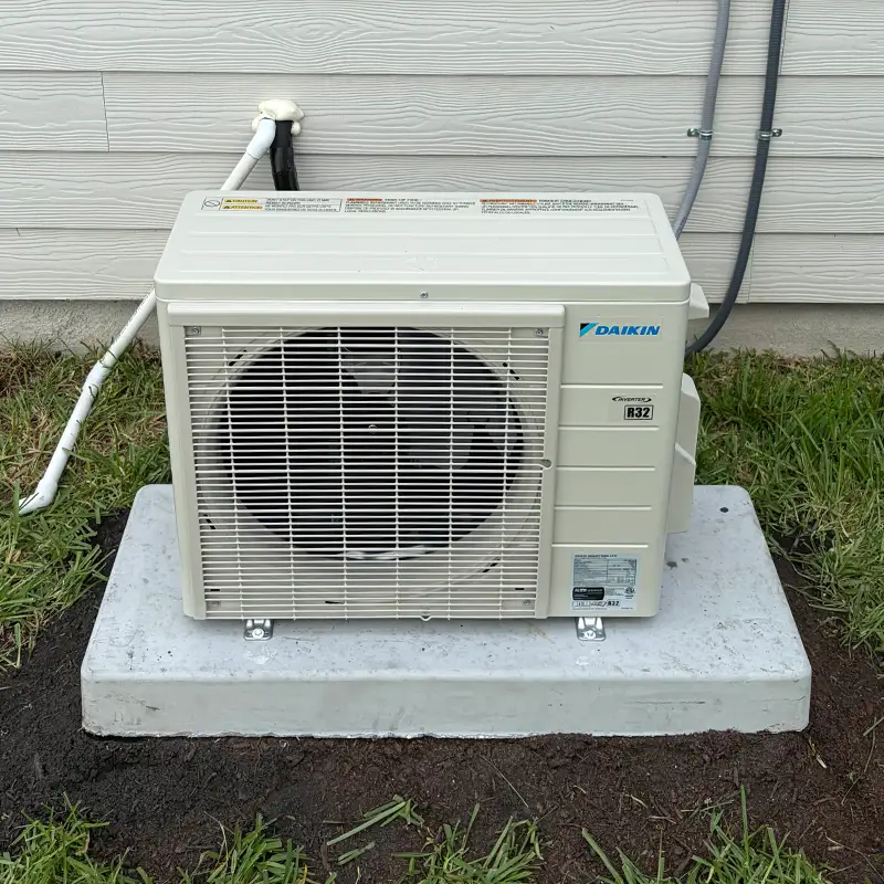 Daikin ductless mini-split outdoor unit installed on a concrete pad in Jacksonville.