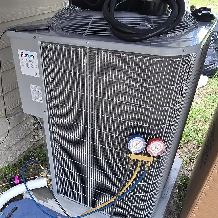 Refrigerant gauges connected to a Carrier Puron Advance AC unit during maintenance in Jacksonville.