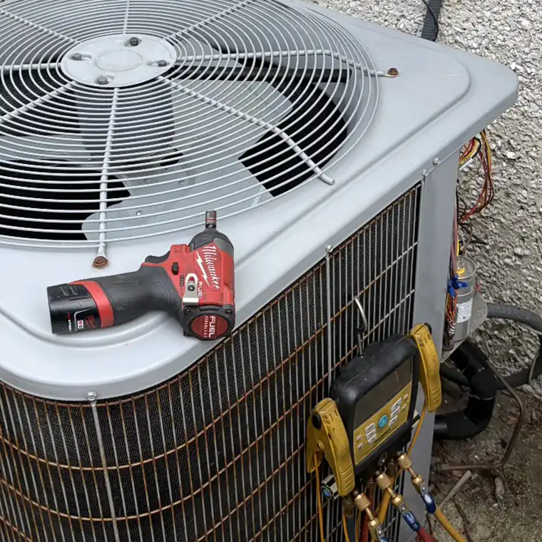 Digital refrigerant gauges and HVAC tools used during AC maintenance in Jacksonville.
