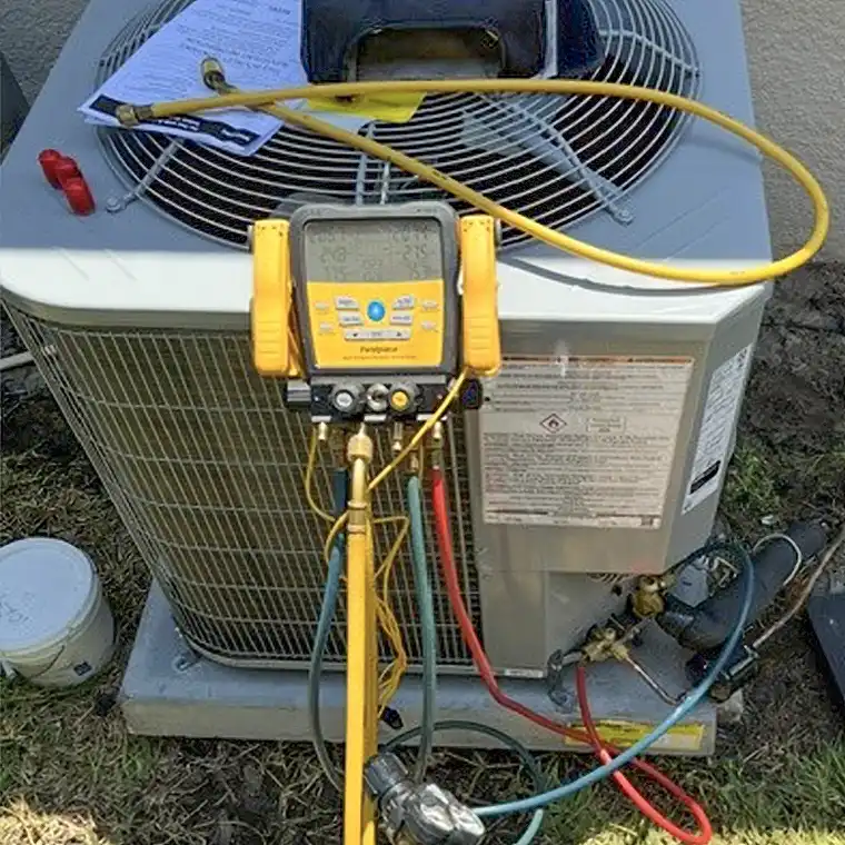 Outdoor AC unit being serviced with digital refrigerant gauges during an AC repair in Jacksonville.
