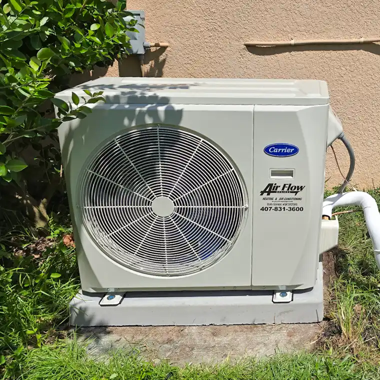 Carrier outdoor AC unit installed on a concrete pad during an AC installation in Orlando.
